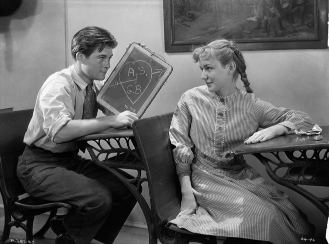 Gilbert Blythe and Anne Shirley in a classroom