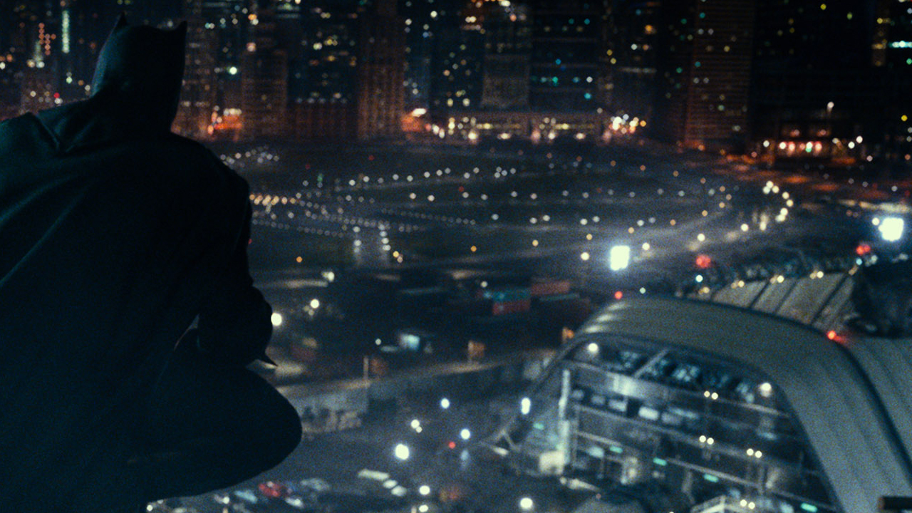 Batman (from behind) watching over the city